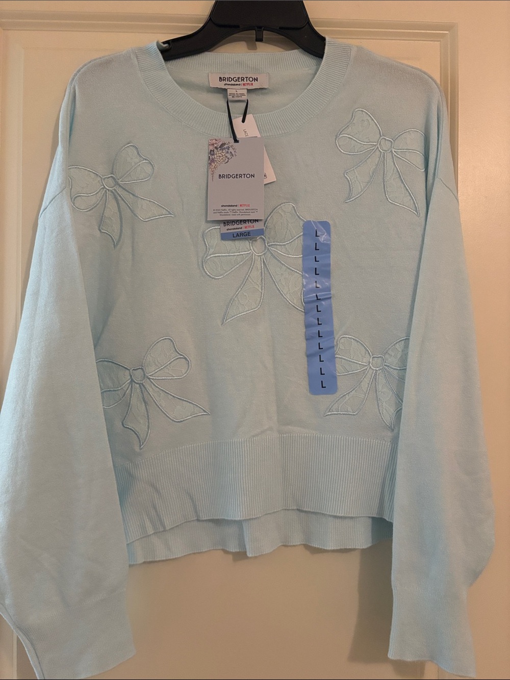 Womenโs Bridgerton Netflix Lace Bow Sweater Blue Size Large